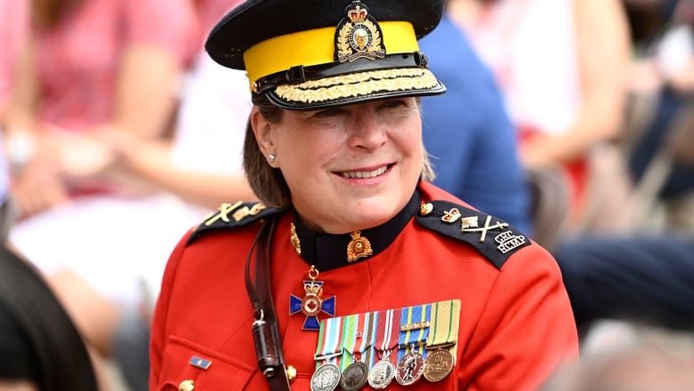 A woman police officer in red uniform