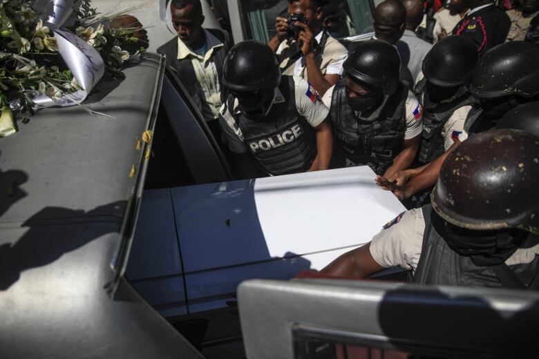 Police transport the coffins of three police officers killed in the line of duty in Port-au-Prince, Haiti on Jan. 31, 2023. The officers were killed in an ambush by gang members in the capital on Jan. 20.