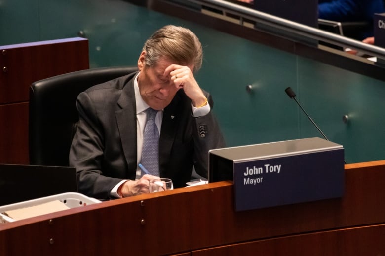 Toronto Mayor John Tory writing at his chambers desk at a Toronto Council Meeting on Feb 15, 2023