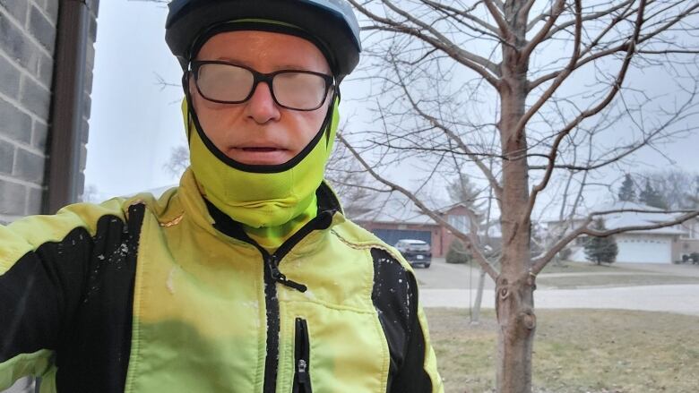 A man wearing foggy glasses and a bike helmet