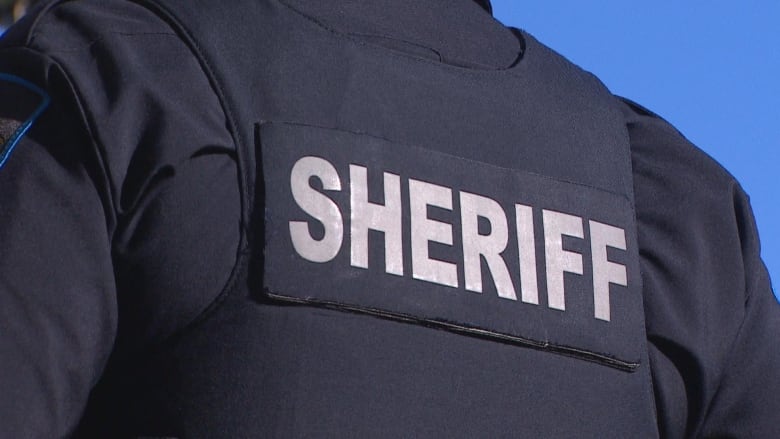 The back of a sheriff uniform reads: 'Sheriff.'