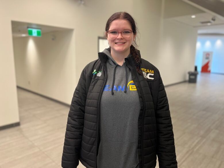 young athlete in Team B.C. hoodie and jacket smiling at the camera