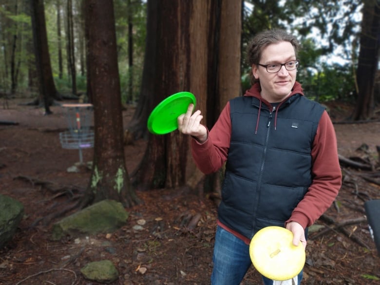 A man holds a frisbee