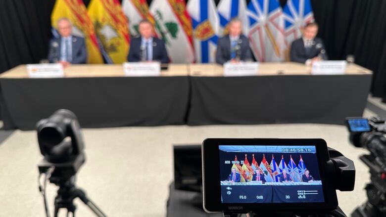 An image of the four premiers sitting at a table.