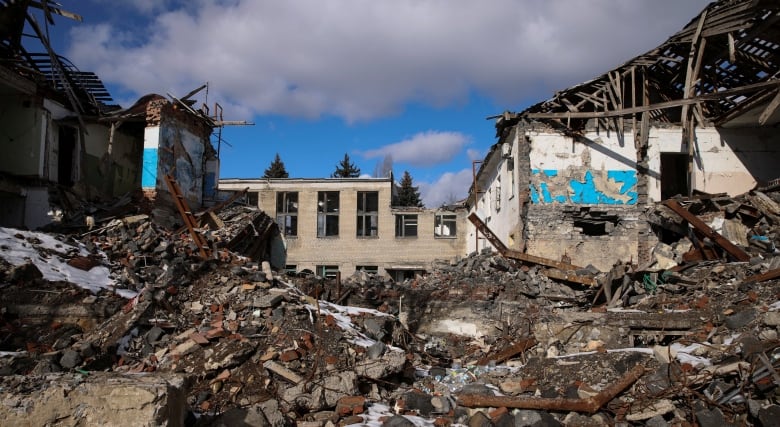 Damaged building and rubble are shown.