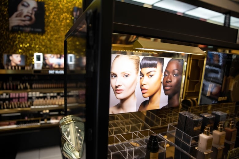 A photograph of makeup models is displayed in a cosmetics store.