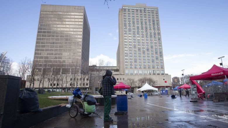 A man with his belongings in the park.