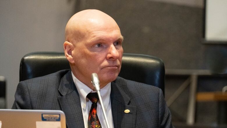 A city official listens during a meeting.