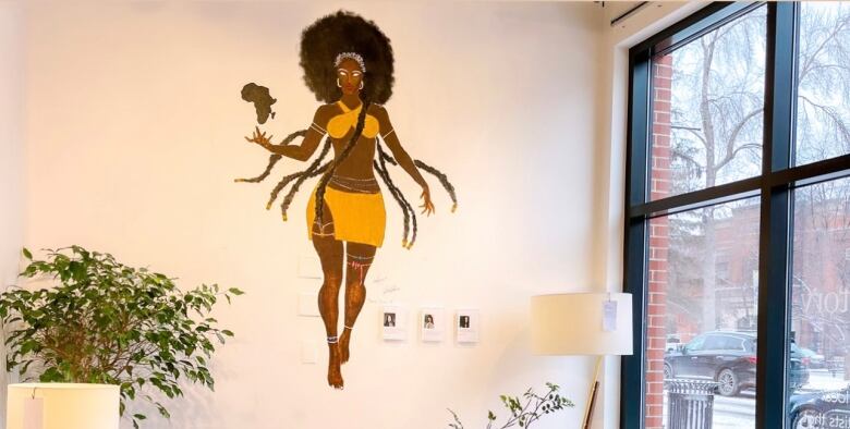 A mural of a Black woman on the wall of a West Elm store.