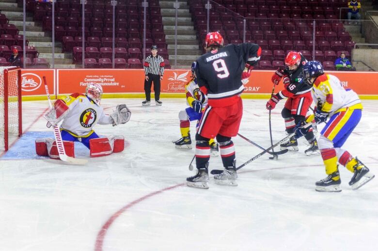 A group of hockey players in action on the ice.