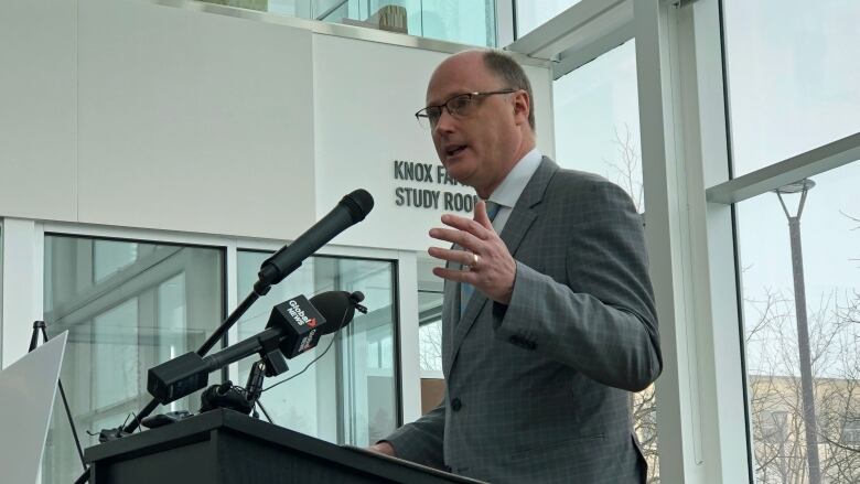 A man speaking at a podium