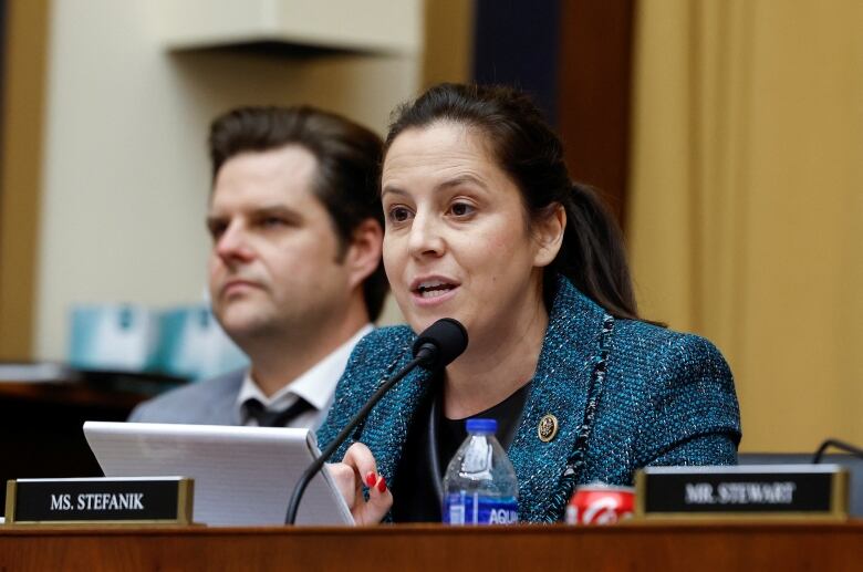 Representative Elise Stefanik speaks at a desk in Congress.