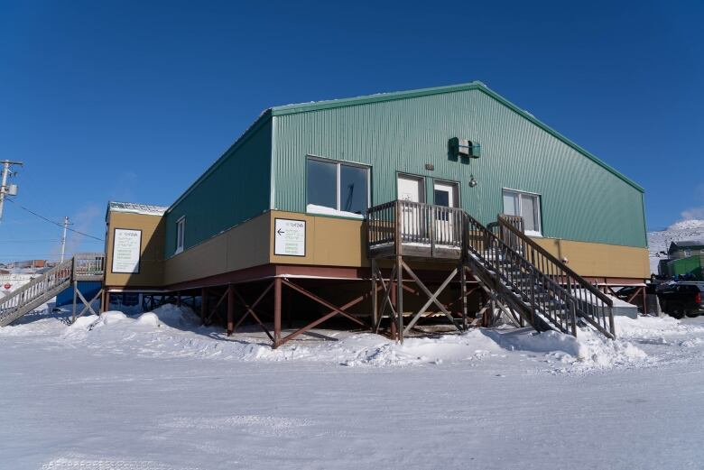 A building with green and yellow siding.