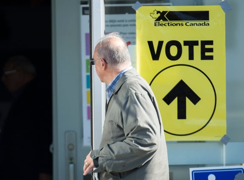 A man arrives to cast his ballot at a polling station on federal election day in Shawinigan, Que.