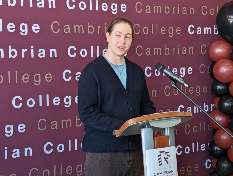 A young man standing at a podium.