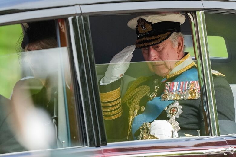 King Charles salutes as he leaves Westminster Abbey following the state funeral service of Queen Elizabeth.