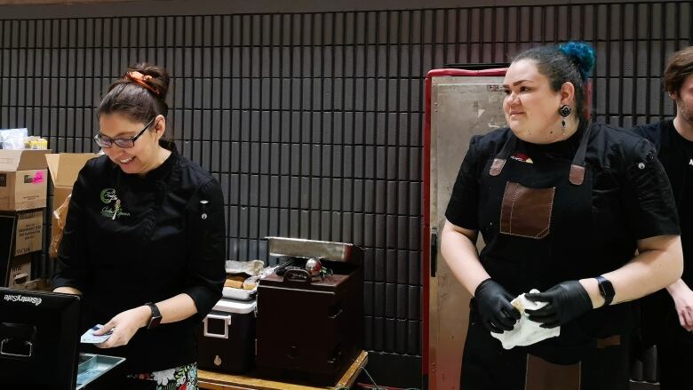 Destiny Moser and Sydney Keedwell serve food at Conestoga College Pow Wow.