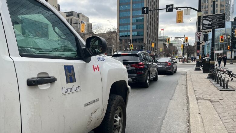 A City of Hamilton vehicle is stopped near an intersection.