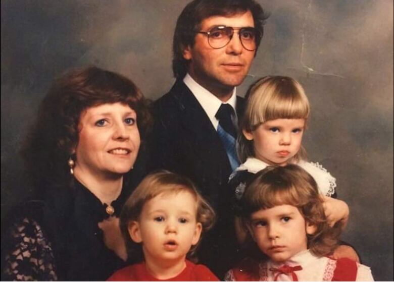 Ammanda Zelinski sits on her mother Kim's lap in a 1996 family portrait.