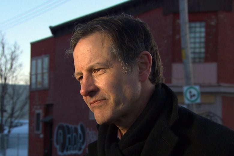 Man with building in background