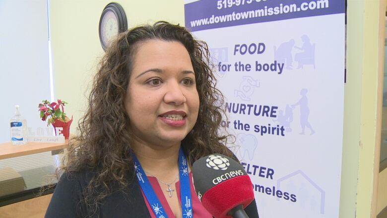 Head-and-shoulders shot of Rukshini Ponniah-Goulin speaking into a CBC microphone.