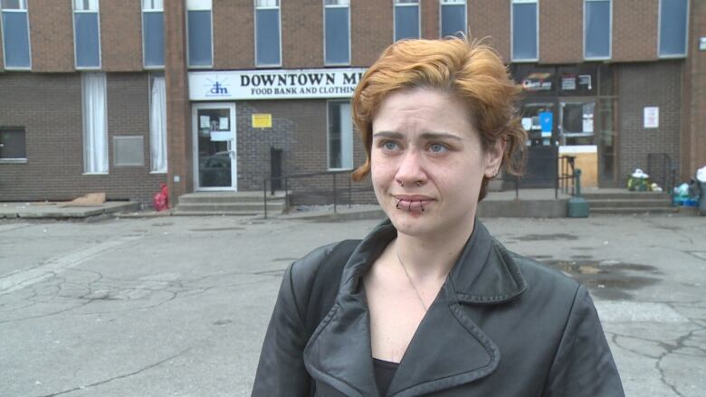 Meighen Pindus stands in front of the Downtown Mission speaking to CBC.