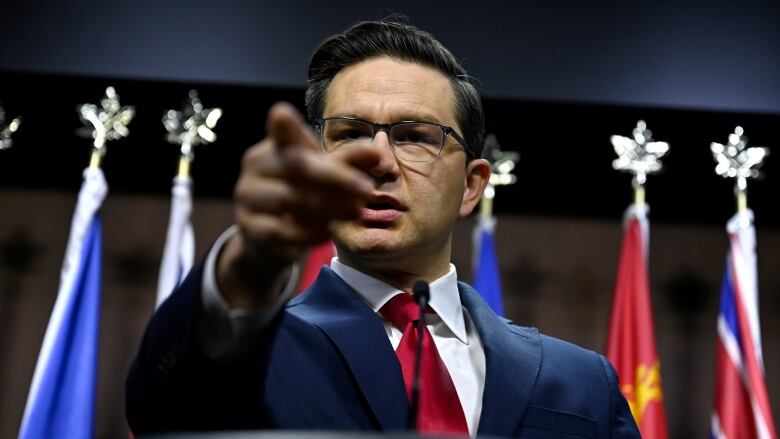 Conservative Leader Pierre Poilievre points a journalist during a press conference on Parliament Hill.