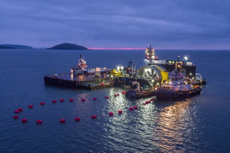 A turbine in the water at night time.