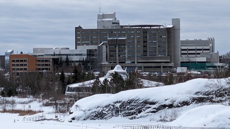 A large hospital and its surrounding campus in the winter.