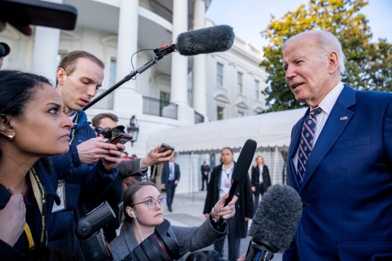 U.S. President Joe Biden speaks to reporters outside the White House.