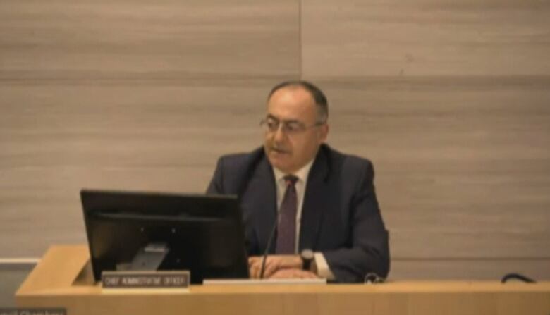 Windsor Chief Administrative Officer Onorio Colucci sitting at his desk in the council chambers.