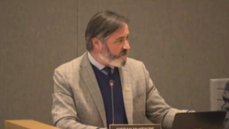 Coun. Kieran McKenzie at his desk in the council chambers. 