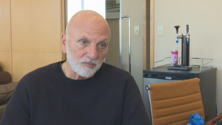 Head-and-shoulders shot of Joe Mikhail in an office. 