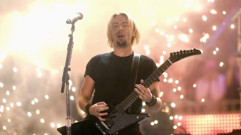 Nickelback's Chad Kroeger plays guitar onstage.