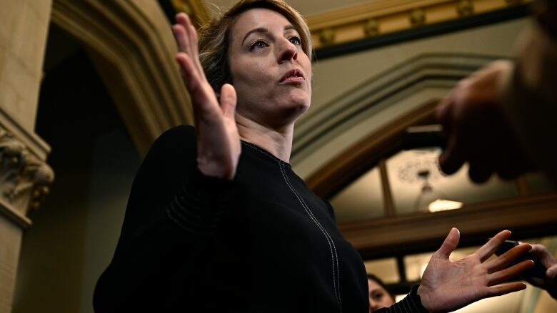 Minister of Foreign Affairs Melanie Joly speaks to reporters before heading into a meeting of the Liberal caucus, on Parliament Hill in Ottawa, on Wednesday, March 8, 2023.