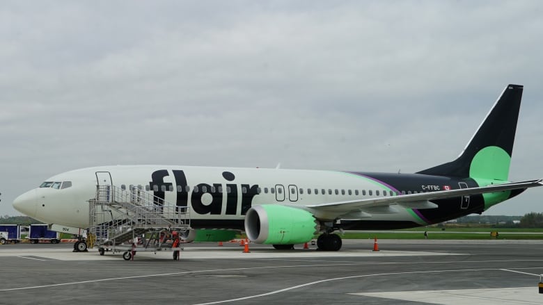 A plane is seen parked on a runway.