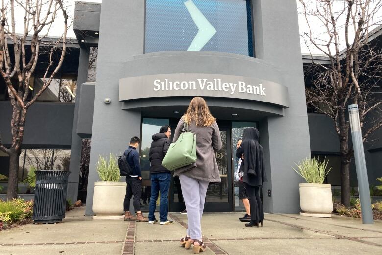 People standing outside of a bank.