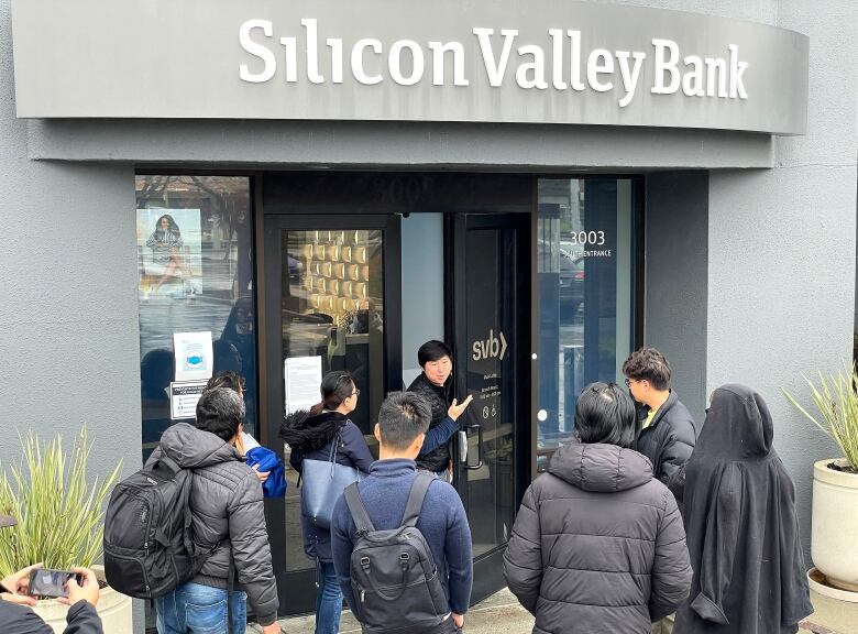 People gather outside a building.