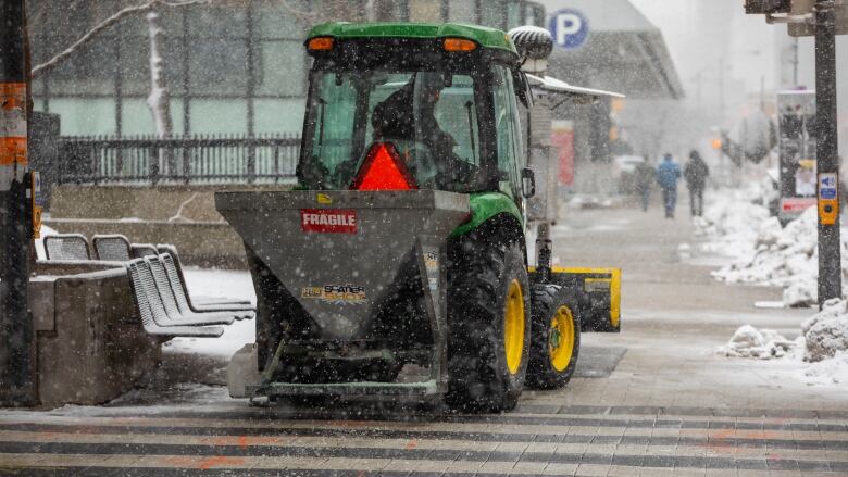 A snow vehicle on Front Street during the snowstorm on March 10, 2023.