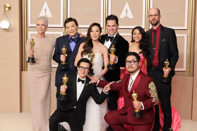 Cast of Everything Everywhere All At Once poses with their Oscars.