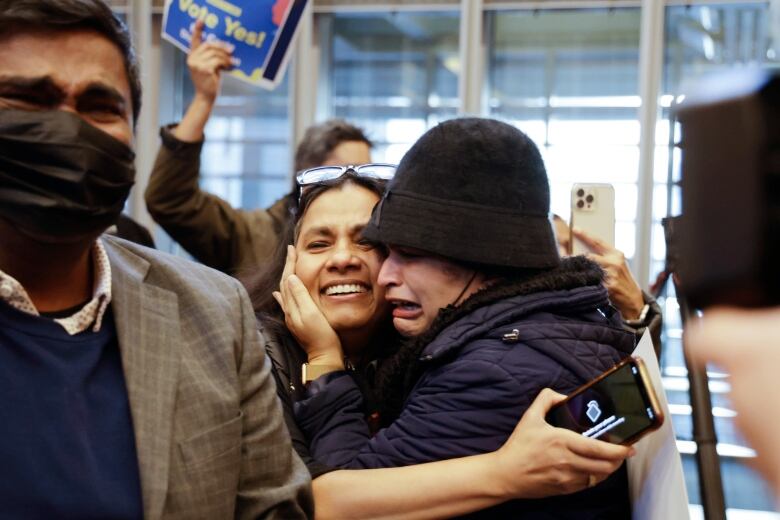 People celebrating and hugging each other