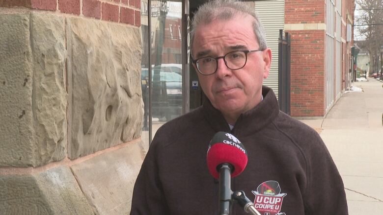 Philip Brown stands outside city hall during an interview with CBC.