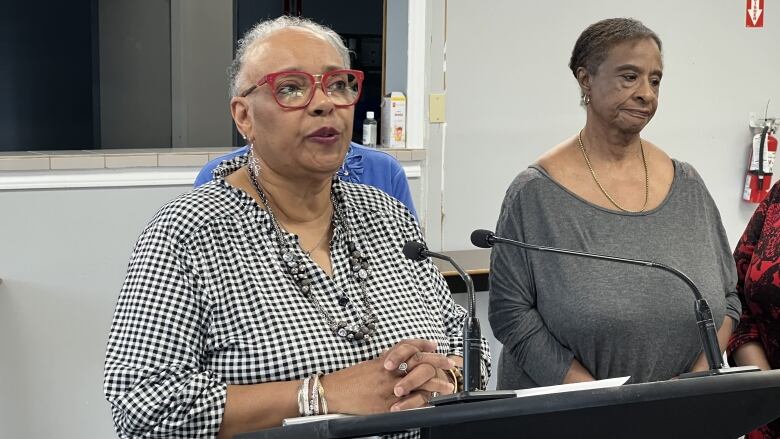 A woman speaks at a podium. 