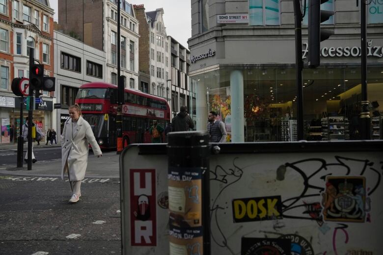 A woman walks around downtown London.