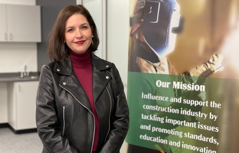 Portrait of Nadine Fullarton in front of construction promotional banner