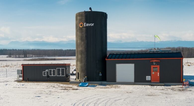 A small tower sits in an open field.