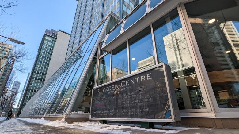 a sign reads elveden centre, behind it, a tall building with lots of windows 