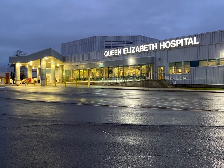 A quiet, overcast look at the Queen Elizabeth Hospital at night.