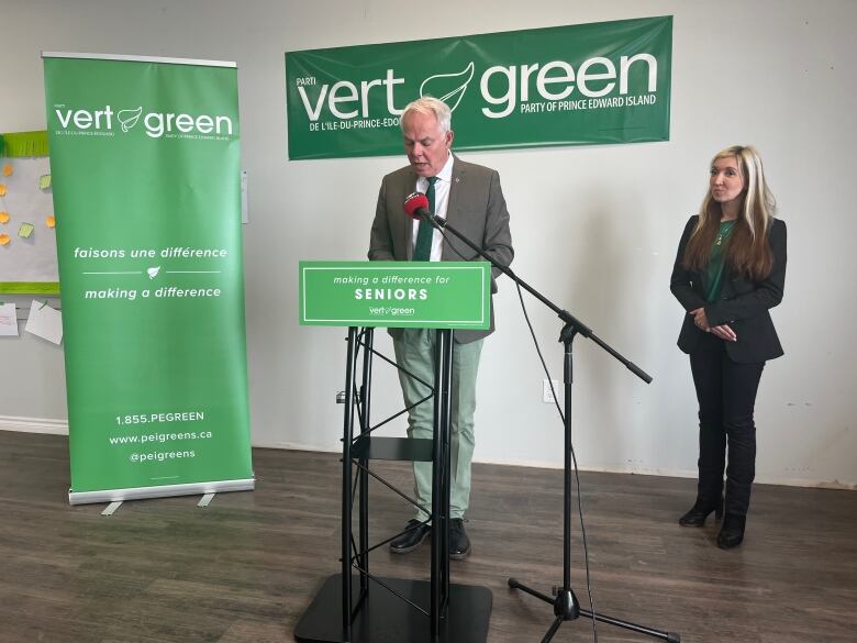 Green Leader Peter Bevan-Baker stands at a podium with Green candidate Lynne Lund. 