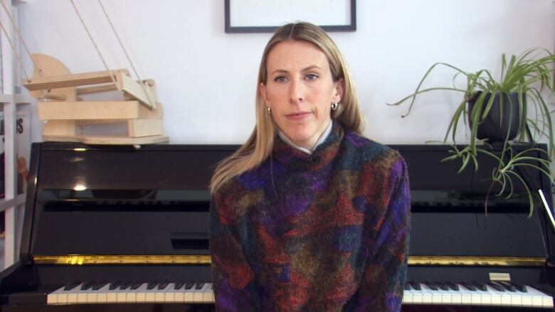 Woman sitting in front of piano